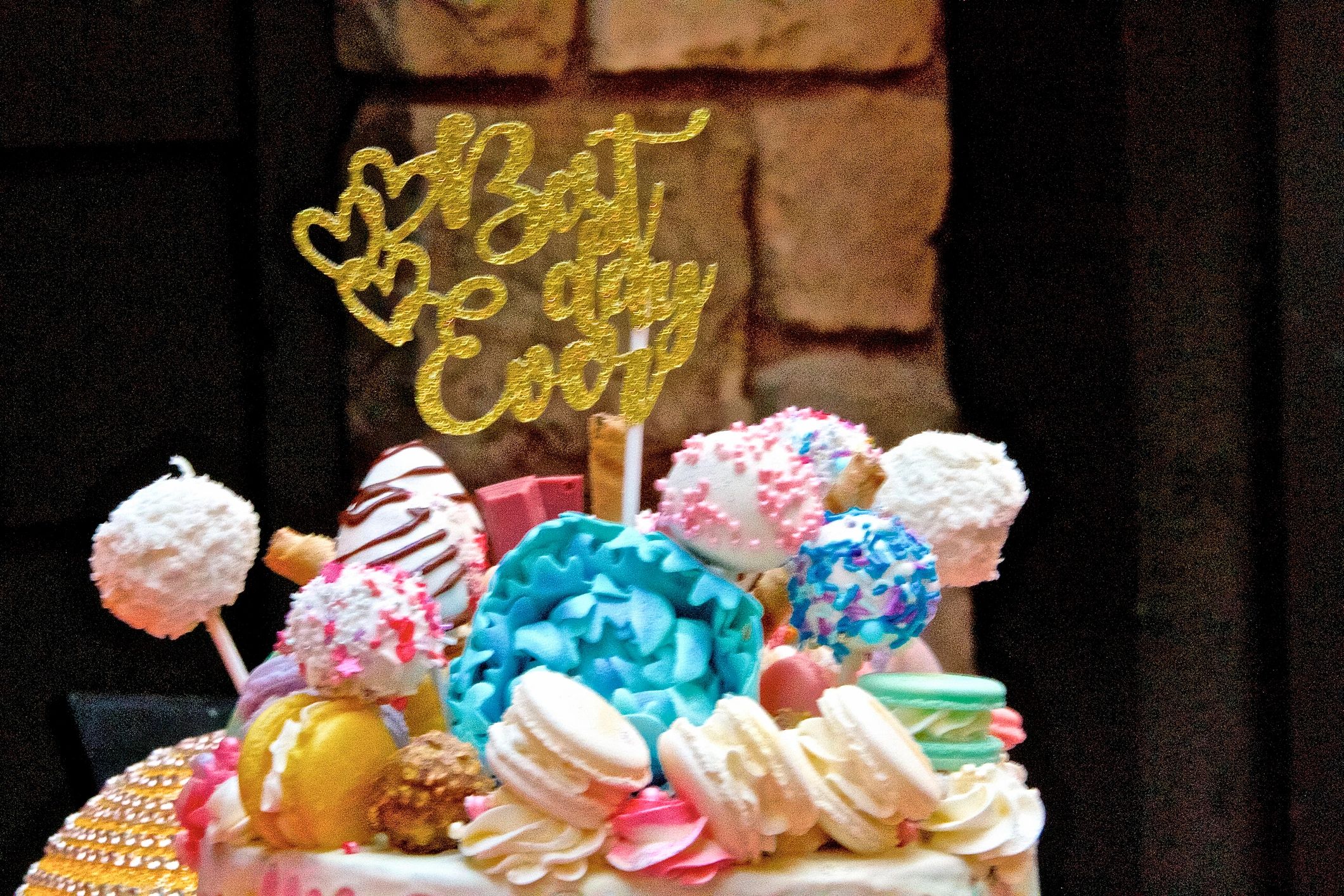 Decorative vibrant coloured birthday cake with cookies